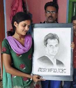 Family of Mohammed Shami hold his portrait